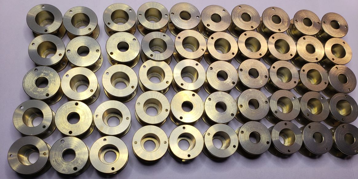 Rows of machined flanged components shown on the original capabilities page
