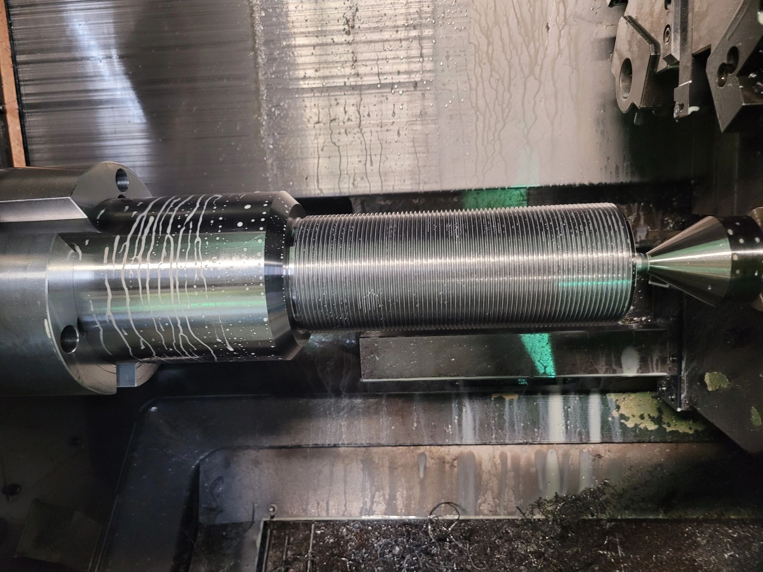 Precision threaded component being machined on a CNC lathe
