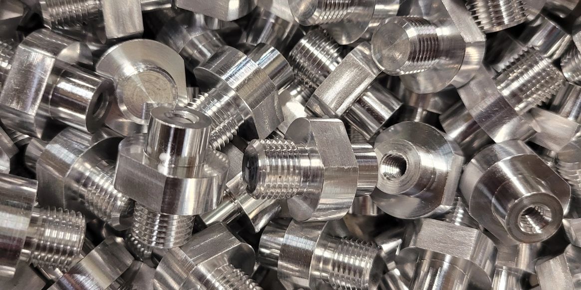 Close-up of Swiss-machined threaded metal components from the original capabilities page